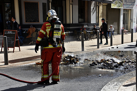 Firefighter puts out trash fire during the demonstration. Acts of incivility punctuated the ninth day of demonstration against the pension reform wanted by the French government and which would raise the retirement age from 62 to 64 years old.