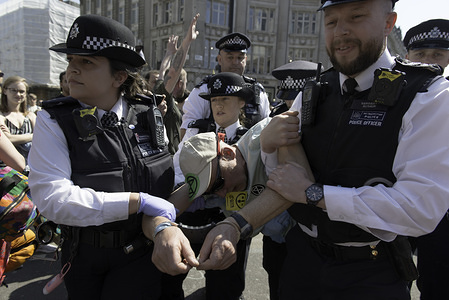 A male activist is seen being arrested by police officers after refusing to head to Marble Arch during the Extinction Rebellion Strike in London.

Environmental activists from Extinction Rebellion movement remained at Oxford Circus after the Berta Cáceres pink boat was removed from police. Activists were in the junction blocking the streets and causing traffic disruptions before police moved in to clear the Extinction Rebellion road blockades. Police have been arresting protesters that refuse to head to Marble Arch.