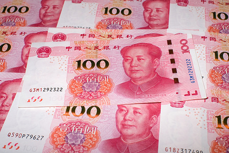 In this photo illustration, the 100-yuan Chinese currency note is placed on the table, and there are some other RMB notes placed together in the background.