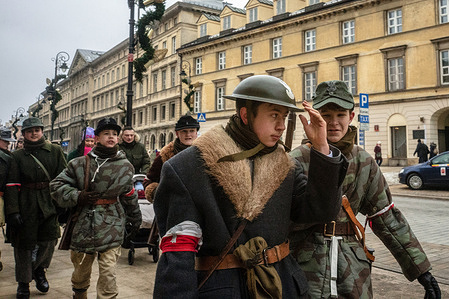 Young historical reenactors in period military dress are seen after the ceremony. On the afternoon of the 14th of February, Poland celebrates the National Day of Remembrance of the Home Army Soldiers, a state holiday commemorating the Polish underground militias during World War II. After a Mass for the fallen at the Basilica of the Holy Cross, a Parade of Respect passes through the streets of Warsaw in the direction of the Monument to the Polish Underground State and the Home Army at the Polish Parliament, where a wreath-laying ceremony takes place.