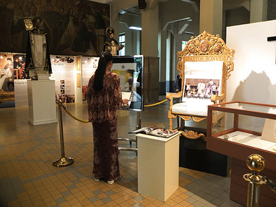A woman devotee preparing to write a message for the late Pope Francis in a provided guestbook. The University of Santo Tomas pays tribute to Pope Francis with an exhibit featuring memorabilia from his 2015 visit to the University. Among the items on display at the main building are the Papal Chair, UST guestbook, & the ID worn by the late pontiff.