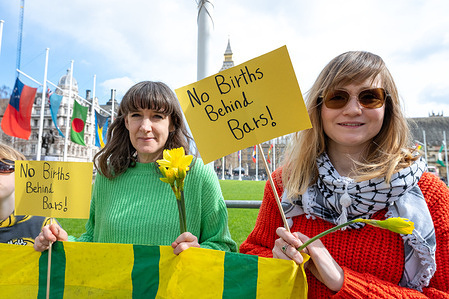 Protesters hold placards reading "No birth behind bars" during the rally. Activists gathered in Parliament Square for a demonstration organised by No Births Behind Bars calling for an end to the imprisonment of pregnant women and mothers. The protest, held ahead of Mother’s Day, highlights the impact of custodial sentences on families and children, with campaigners urging the government to adopt community sentences instead of prison for pregnant women and primary carers. Demonstrators carried flowers, placards and banners expressing solidarity with mothers in prison and calling for reforms to the justice system.