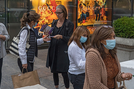 Animal rights activist hands out flyers during an Anti-Fur March on Fifth Avenue in New York City. Animal rights activists from Fur Free NYC, a coalition of not-for-profit organizations working to ban the sale of fur in New York City, peacefully protested asking New Yorkers to urge their New York City Council Members to support bill Intro 1476 for fur free NYC.