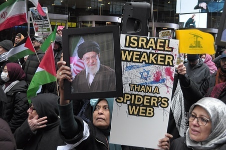 A demonstrator holds a photo of Ali Khamenei during a rally on Al Quds Day in Times Square. On Al Quds Day, demonstrators in New York City demanded freedom for Palestine and opposed the United States’ and Israel’s war against Iran. Al Quds Day occurs on the last Friday of the Islamic holy month of Ramadan. On this day, protests take place worldwide against Israel’s settlement of Palestine.