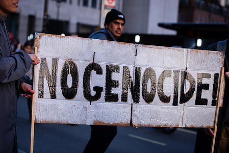 A protestor holds a banner at the Day of Action for Palestine – Ceasefire Now! Demonstration. Demonstrations took place across the UK for a ceasefire in Gaza.