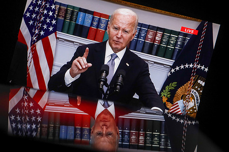 In this photo illustration showing a screen, current US President Joe Biden is seen speaking from the Roosevelt Room of the White House in Washington. President Biden and Vice President Harris held a briefing to discuss the incident and express support for Donald Trump. Biden called for an investigation into the incident and expressed condolences to the family of the victim who rushed to protect his family during the shooting and was killed. The suspect in the shooting, 20-year-old Thomas Matthew Crooks, was arrested and charged with attempted murder.
