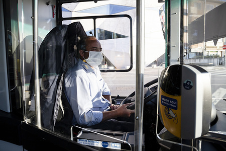 A bus driver seen being protected by a clear plastic panel as a precaution against the Coronavirus (Covid-19). Since the state of emergency was declared in Portugal, passengers have to enter at the front of the bus and it’s became mandatory to wear a mask and pay for a ticket.