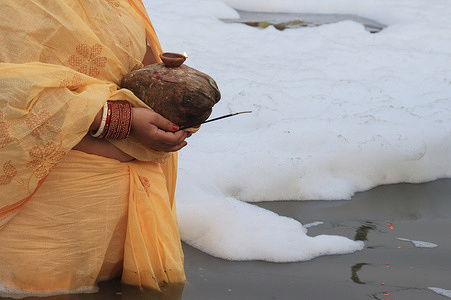 Devotee offers prayers to the sun during the Chhath puja in the Yamuna River.
Chhath Puja is a Hindu festival where devotees pray to sun god and offer Prasad and special delicacies at sunset and before sunrise and end their fast by eating 'Prasad' and special delicacies. Despite rising cases of coronavirus pandemic people are celebrating this auspicious festival with zeal and zest.