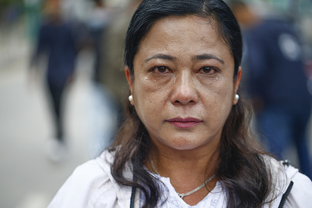 A woman at a rally with teary eyes demands that the government expedite search and rescue efforts at hydropower stations, at Maitighar Mandala in Kathmandu.