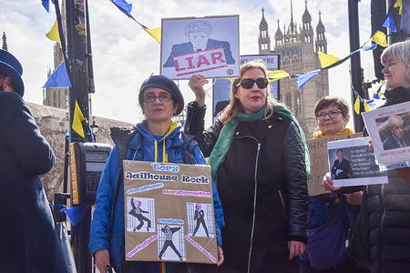 Protesters hold anti-Boris Johnson placards during the demonstration. Anti-Boris Johnson protesters gathered outside the parliament as the former Prime Minister faced questioning at the Partygate committee hearing.