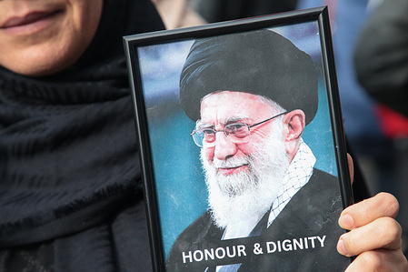 A protester holds a poster of the former Iranian Supreme Leader Ali Hosseini Khamenei during demonstration against Israeli attacks on Iran during al-Quds Day in London. The annual protest, originally planned as a march, was held as a static rally after the government banned the march.