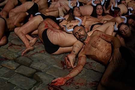 Members of the PETA and ANIMALISNATURALIS platforms, half-naked with bull horns perform during the demonstration. A demonstration against bullfights and the running of the bulls was held in Pamplona, ​​Navarra, Spain, just hours before the start of the San Fermín festival.