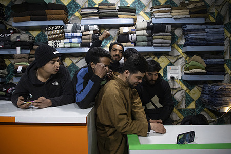 Kashmir residents seen watching the live broadcast of the ICC Men’s T20 World Cup 2026 Group A match between arch rivals India and Pakistan on a mobile phone screen inside a shop. The highly anticipated clash in Colombo carries high stakes, unfolding against a backdrop of long running geopolitical tensions between the two nuclear armed neighbours, including a sharp escalation in May 2025 following a deadly militant attack in Indian administered Kashmir that triggered cross border military exchanges before a ceasefire was reached. The match has also been the subject of political controversy, with Pakistan initially announcing it would boycott the fixture in protest over Bangladesh’s removal from the tournament after the Bangladesh team refused to travel to India for its scheduled matches citing security concerns, before reversing its decision amid international appeals.