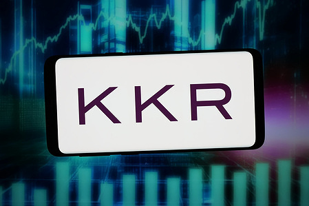 In this photo illustration, the logo of US investment company KKR Co. Inc. is seen displayed on a smartphone in front of an abstract background on a computer screen.