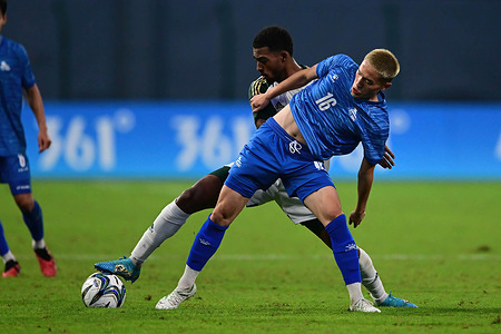 Buyannemekh Ganbat (front) of the Mongolia football team and Mohammed E S Alyami (back) of the Saudi Arabia football team seen in action during the 19th Asian Games 2023 Men's football group round Group B match between Saudi Arabia and Mongolia at Linping Sports Centre Stadium. Final score; Saudi Arabia 3:0 Mongolia.