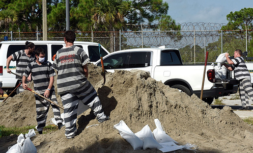 Inmates provided by the Brevard County Sheriff's Office fill sandbags for distribution to local residents at Mitchell Ellington Park in preparation for the arrival of Hurricane Isaias.
The storm is forecast to approach the coast of Florida as a Category 1 storm and then parallel the Atlantic coast as it moves north.
