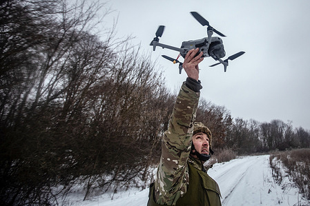 Ukrainian soldier with a reconnaissance drone on the Sumy front. In the cold of winter, the Ukrainian army fights by using reconnaissance drones to locate targets and artillery to attack them.