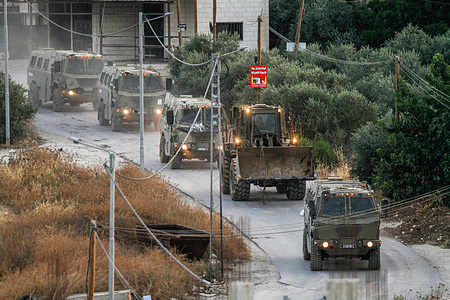 Dozens of Israeli military vehicles leave the Jenin refugee camp. Palestinian health officials said at least 10 Palestinians were killed in Israeli raids and airstrikes. Army spokesman Rear Admiral Daniel Hagari said Israel launched the operation after receiving around 50 attacks over the past year from Jenin.