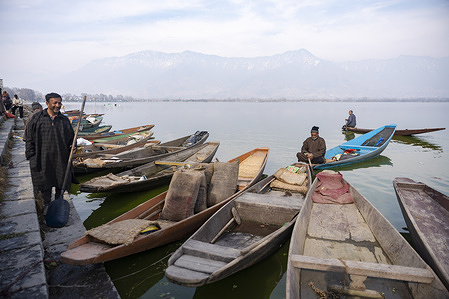 A boatman rows past a line of farmers boats moored along the banks of Dal Lake on a sunny day in Srinagar. After Friday prayers at the historic Dargah Hazratbal Shrine in Srinagar, people make their way to the banks of Dal Lake, where a floating marketplace comes alive. Farmers and fishermen arrive in wooden boats laden with freshly harvested vegetables and glistening fish, selling their produce at reasonable prices. The unique market springs to life only on Fridays.