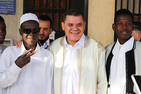 Libyan Prime Minister Abdul Hamid Dbeibeh (C) poses for a group photo as he attends Eid al-Fitr prayers marking the end of the holy fasting month of Ramadan at the Al-Ghalban Mosque in Misrata.