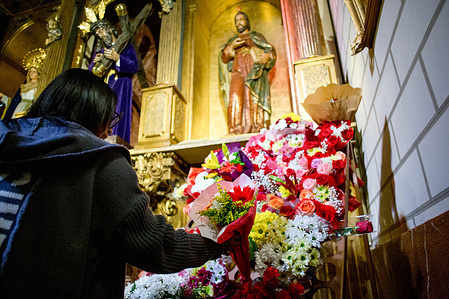 A woman places a bouquet of flowers at the feet of the statue of Saint Jude Thaddeus at the Church of Santa Cruz, in downtown Madrid, during the celebration of Saint Jude Thaddeus Day. Every October 28th, the feast day of Saint Jude Thaddeus, the patron saint of lost and difficult causes, is celebrated.