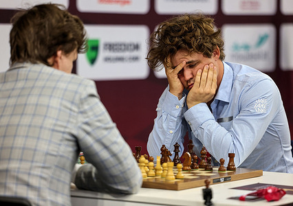 Norwegian Magnus Carlsen plays against Russian Vladislav Artemyev during the 2025 World Rapid and Blitz Chess Championships, organized by the International Chess Federation (FIDE), at the Sports and Events Complex in Qatar University.