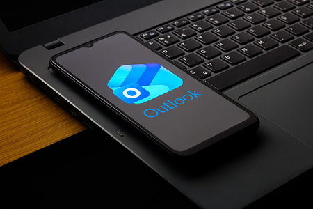 In this photo illustration, the Microsoft Outlook logo is seen displayed on a smartphone screen.