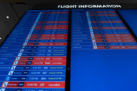 Flight information boards show extensive cancellations and delays at Washington Reagan National Airport, Friday, Nov. 7, 2025, in Arlington, Va. The Federal Aviation Administration has ordered flights scaled back at 40 major airports around the country as the government shutdown reaches 38 days.