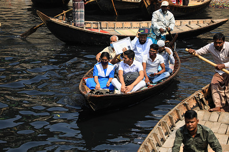 Students cross on a boat over the pitch-black water of the Buriganga River in Dhaka. Water pollution at Buriganga River has reached alarming levels. Millions of cubic meters of toxic waste from the tanneries and thousands of other industries, topped with a massive volume of untreated sewage from Dhaka city.