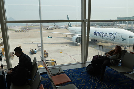 People wait for their flights at Hong Kong International Airport. Hong Kong International Airport, one of the world's busiest aviation hubs, serves as a primary gateway for international passengers traveling between Asia, Europe, and North America. There are millions of people travel through this airport annually and hundreds of flights depart from the airport everyday.