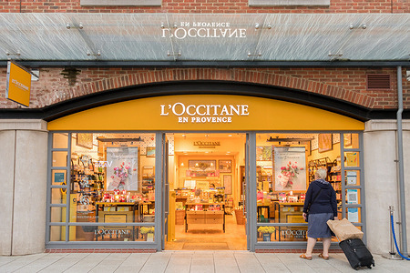 A woman stands outside a L'Occitane en Provence at the Gunwharf Quays Shopping Centre in Portsmouth.
