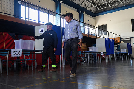 Two municipal officers check the preparation of the polling station for the second round of the Presidential Election, Chile 2025. Public workers prepare a polling station ahead of the second round of Chile’s 2025 presidential election. The runoff, scheduled for Sunday, December 14, will be contested between Jeannette Jara of the left-wing coalition and José Antonio Kast of the Republican Party. The vote will decide Chile’s next president, who is set to take office in March 2026.