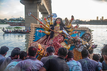 Hindu devotees carry an idol of the goddess Durga during the final day of Durga Puja festival. The four-day long Durga Festival is celebrated across Bangladesh and culminates in the immersion of the idols of Hindu goddess Durga to symbolise power and the triumph of good over evil in Hindu mythology.