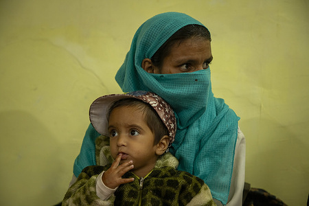 A Kashmiri mother with her son takes shelter at a government degree college after being evacuated for safety following cross-border shelling near the Line of Control in Salamabad village in Uri. India and Pakistan engaged in their deadliest border clash in over 20 years, following India's Operation Sindoor missile strikes. Cross-border shelling killed at least 26 civilians in Pakistan and 10 in India, injuring dozens more. Homes were damaged, forcing evacuations and leaving families in fear along the militarised frontier.