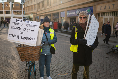 Demonstrators are seen marching while holding placards during the protest. Quakers for Climate Justice are asking for a stop to new oil extraction, and a stop to UK airport expansions.