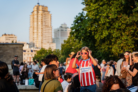 A child seen enjoying the solar eclipse. People gather to watch the total solar eclipse at the Temple of Debod park in Madrid. In Madrid, the eclipse appears as a very deep partial eclipse, with more than 99% of the Sun covered by the Moon.