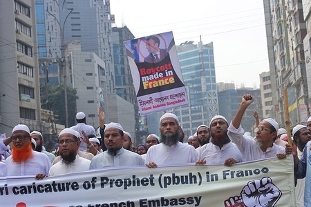 Muslim protesters hold a banner during the protest in Dhaka.
The Islami Andolon, one of Bangladesh's largest Islamist parties, hold a protest march calling for the boycott of French products and denouncing French president Emmanuel Macron for his remarks ‘not to give up cartoons depicting Prophet Mohammed’. Macron's remarks came in response to the beheading of a teacher, Samuel Paty, outside his school in a suburb outside Paris earlier this month, after he had shown cartoons of the Prophet Mohammed during a class he was leading on free speech.