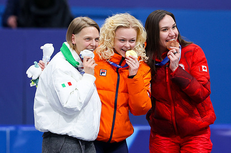 Gold medalist Xandra Velzeboer of Netherlands, Silver medalist Arianna Fontana of Italy and Bronze medalist Courtney Sarault of Canada pose seen on the podium during the Short Track Speed Skating Finals Women's 500m of the Milano Cortina 2026 Winter Olympics at Milano Ice Skating Arena in Milan