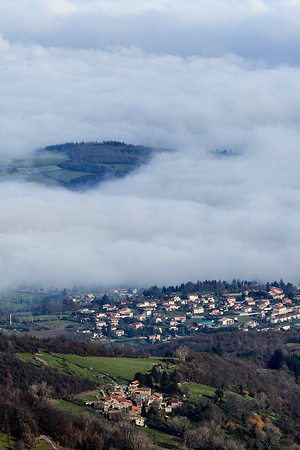 Fog is seen in the Rhone valley. Aerial view of the Rhone Valley with the villages of Pelussin, Loire above the fog.