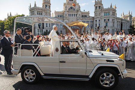 Pope Leo XIV waves and greets the faithful from his popemobile upon arriving at Plaza de Cibeles in Madrid to celebrate the Corpus Christi Mass during his Apostolic Journey to Spain.