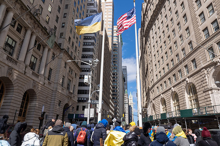 The Ukrainian flag is raised to fly beside the Stars and Stripes at a Ukrainian flag raising ceremony to show solidarity with the Ukrainian people at the historic Bowling Green Park in Lower Manhattan, New York City. The International Criminal Court (ICC) on Friday issued an arrest warrant for Russian President Vladimir Putin and Russian official Maria Lvova-Belova for an alleged scheme to deport Ukrainian children to Russia.