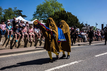 Crowds line the streets to watch Reenactors dressed as a camel during the annual Folk Festival parade led by mayor Simon Yates, which drew thousands of people to the sleepy riverside town of Upton Upon Severn in Worcestershire.
The Folk Festival from Upton Upon Severn is a yealry event who attract thousand of visitors in one of the smallest town in the Malvern Hills District of Worcestershire.