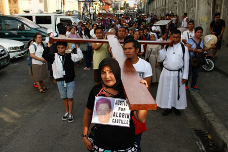 Nanette Castillo, mother of Aldrin Castillo, carries the cross that leads the walk for justice in Quezon City. Aldrin was gunned down in Tondo, Manila, last year by unknown assailants. Members of the clergy and the Sto. Domingo community held a Penitential Walk in Quezon City as they call for the respect of life, and to denounce the killings that plagued the nation since President Duterte's war on drugs started almost two years ago.