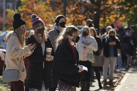 Voters wait in line to vote early at Monroe County election central on Monday before the 2020 presidential election. 
Voters stretched four blocks, and waited in line two or more hours to vote. United States President Donald J. Trump is running for re-election against Democratic challenger Joe Biden.