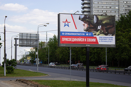 A recruitment poster is displayed near one of the two residential buildings that were hit by a Ukrainian military drone.