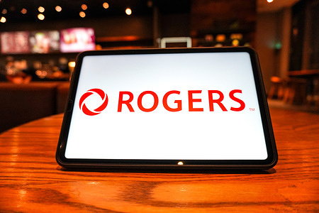 In this photo illustration, a Rogers Communications Inc. logo is seen displayed on the screen of a tablet.