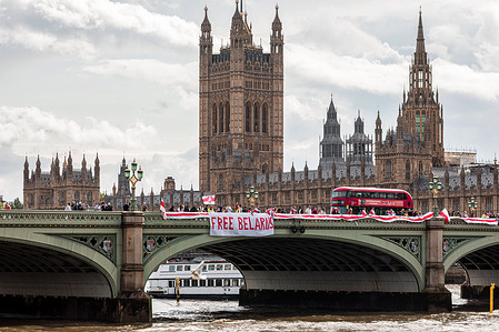 Protesters hang a flag of Belarus and a banner that says Free Belarus at the Westminster bridge during the demonstration. .
Belarusians gathered at Parliament Square and later marched towards Westminster Bridge, before hanging a Belarus flag over the bridge. August 8th marks one year since the presidential elections of 2020, which opponents claim were rigged. The march was in protest against repression under the Lukashenko regime and called for freedom for political prisoners.