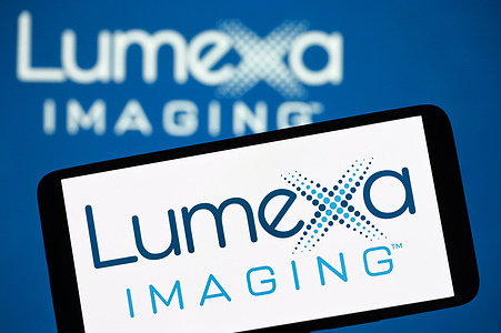 In this photo illustration, the Lumexa Imaging logo is seen on a smartphone and in the background.