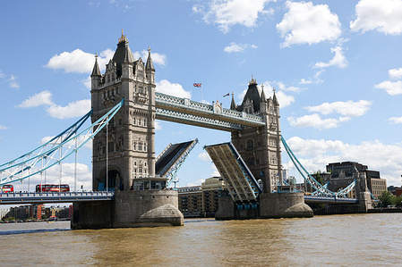 A view of Tower Bridge as it opens. Tower Bridge is an iconic landmark in London, England, spanning the River Thames. Opened in 1894, it is a bascule and suspension bridge.