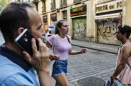 A young tourist crosses the police line to leave the area of the attack, after a van ploughed into the crowd, killing and injuring several people.